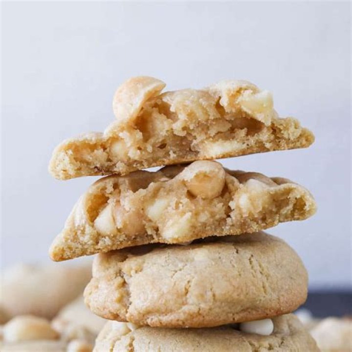 White chocolate macadamia nut cookie with a bite taken out of it.